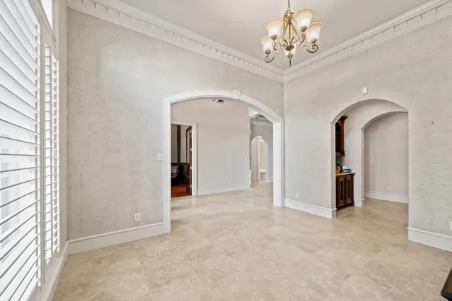 a view of empty room with a ceiling fan and window