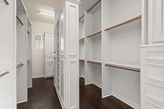 a bathroom with a granite countertop toilet sink and mirror