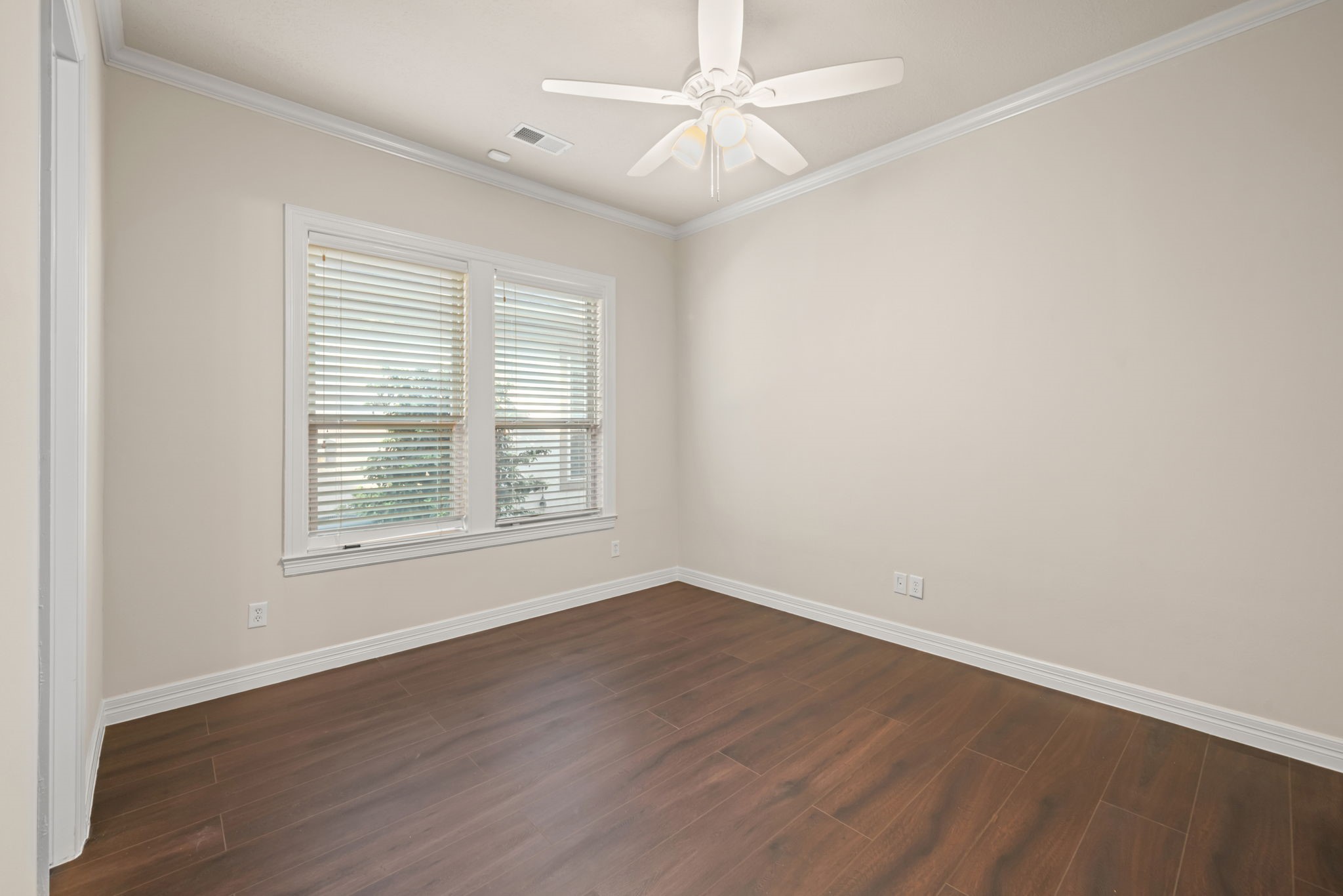 17010 Lapeer Court Spring, TX 77379 - Photo 29 of 36 an empty room with wooden floor ceiling fan and windows
