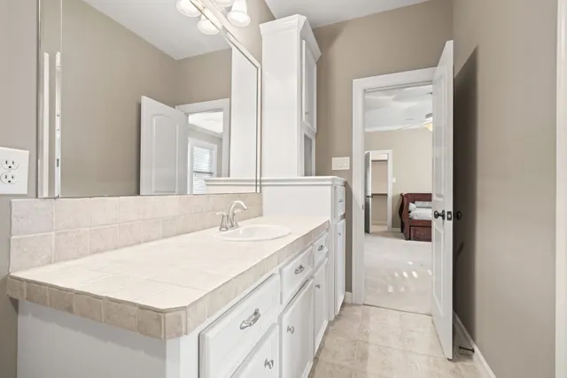 a living room with furniture and a ceiling fan