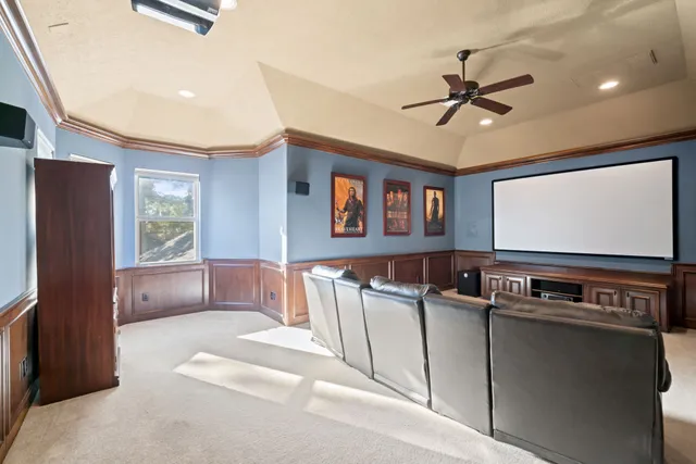 a bedroom with a bed and ceiling fan