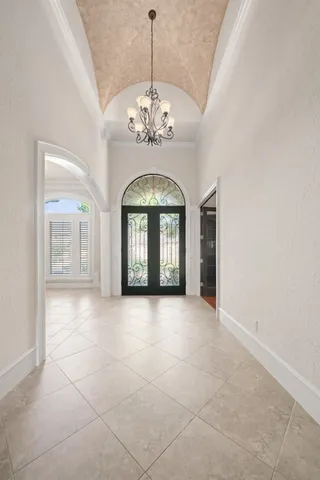 a view of an empty room with a chandelier