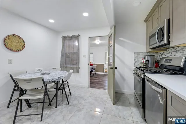a kitchen with a table and chairs in it