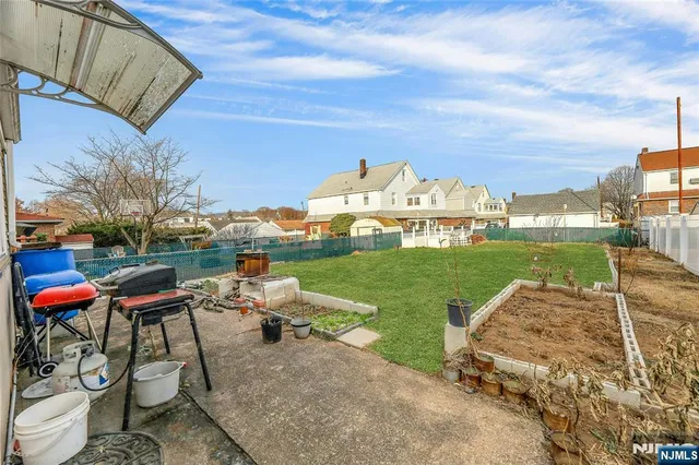 a backyard of a house with table and chairs
