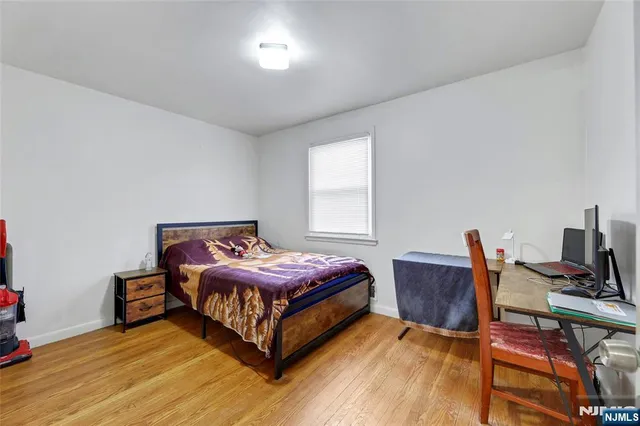 a bedroom with a bed and a desk in it