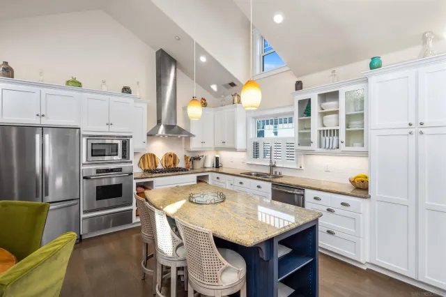 a kitchen with a stove a sink and a refrigerator