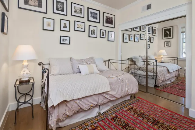 a bedroom with a bed and lamp on desk