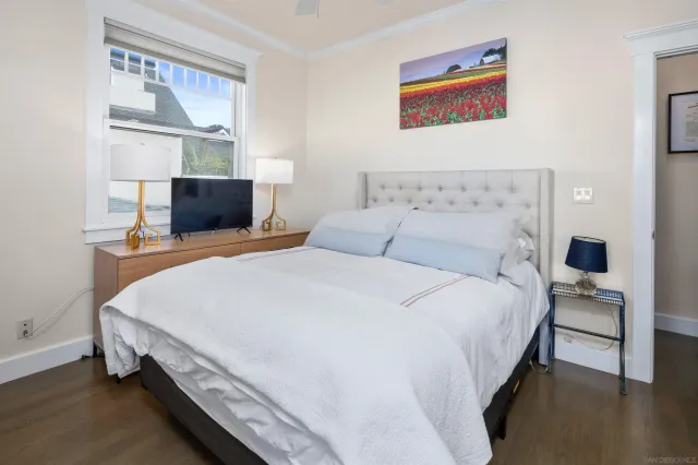 a spacious bedroom with a bed and window