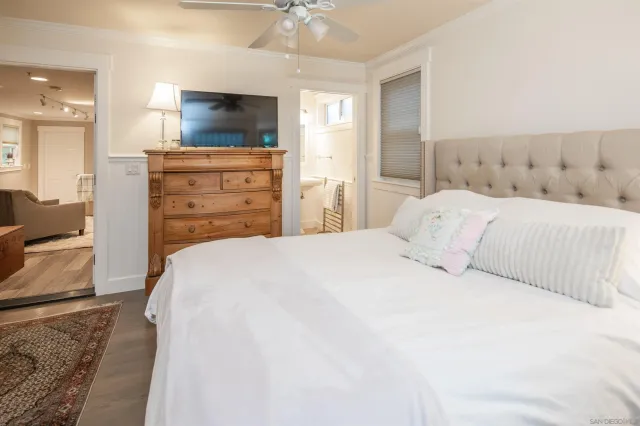 a bedroom with a bed and a flat screen tv