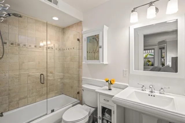 a bathroom with a sink toilet and shower