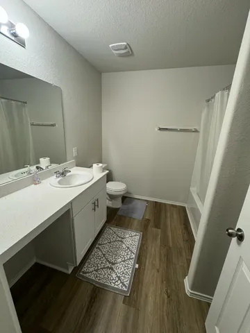 a spacious bathroom with a sink and a mirror