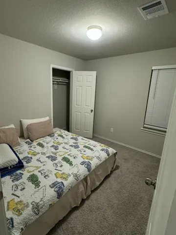 a bedroom with a bed and a dresser