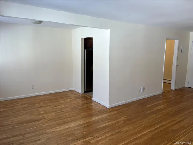 a view of a hallway with wooden cabinets