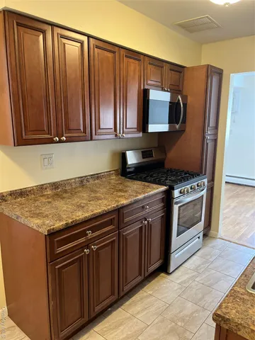 a view of a terrace with a table and chairs in the garden