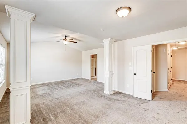 a view of a livingroom with a ceiling fan and window