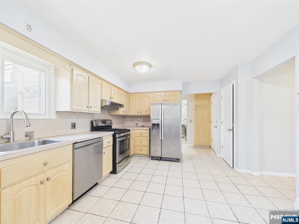 50 Hepburn Road Clifton, NJ 07012 - Photo 13 of 42 a kitchen with a sink a refrigerator and cabinets
