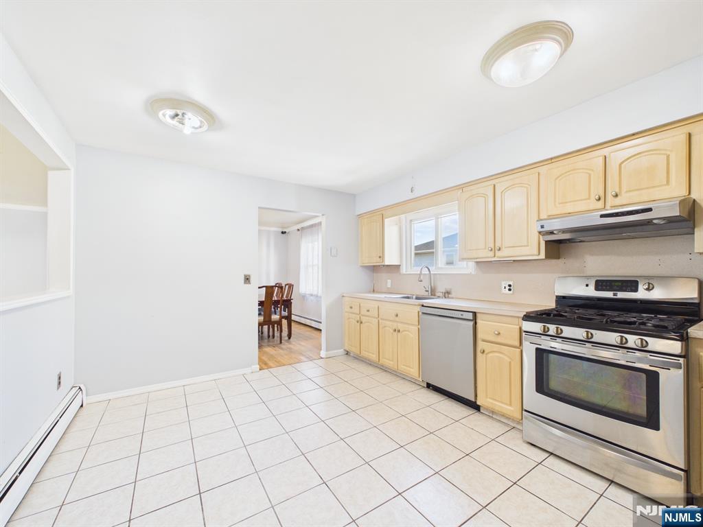 50 Hepburn Road Clifton, NJ 07012 - Photo 14 of 42 a kitchen with a stove top oven sink and cabinets