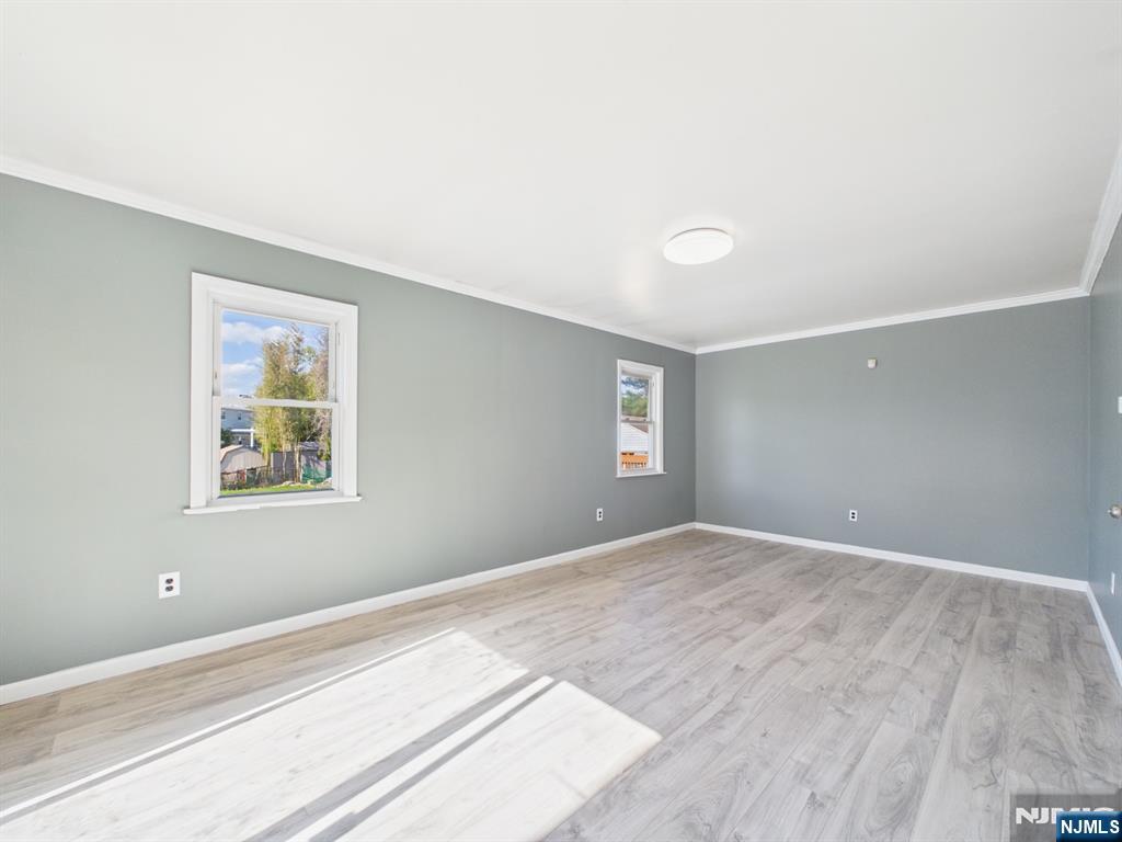 50 Hepburn Road Clifton, NJ 07012 - Photo 15 of 42 a view of an empty room with wooden floor and a window