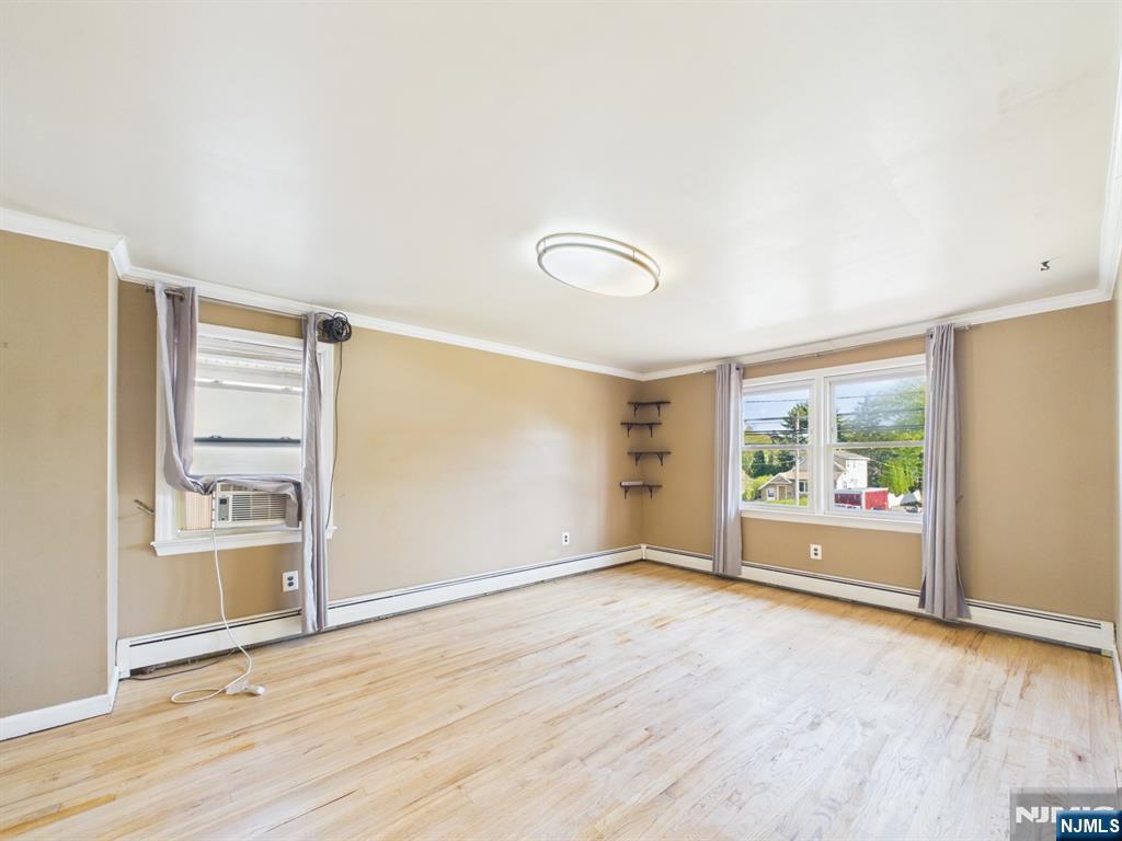 50 Hepburn Road Clifton, NJ 07012 - Photo 24 of 42 an empty room with wooden floor and windows