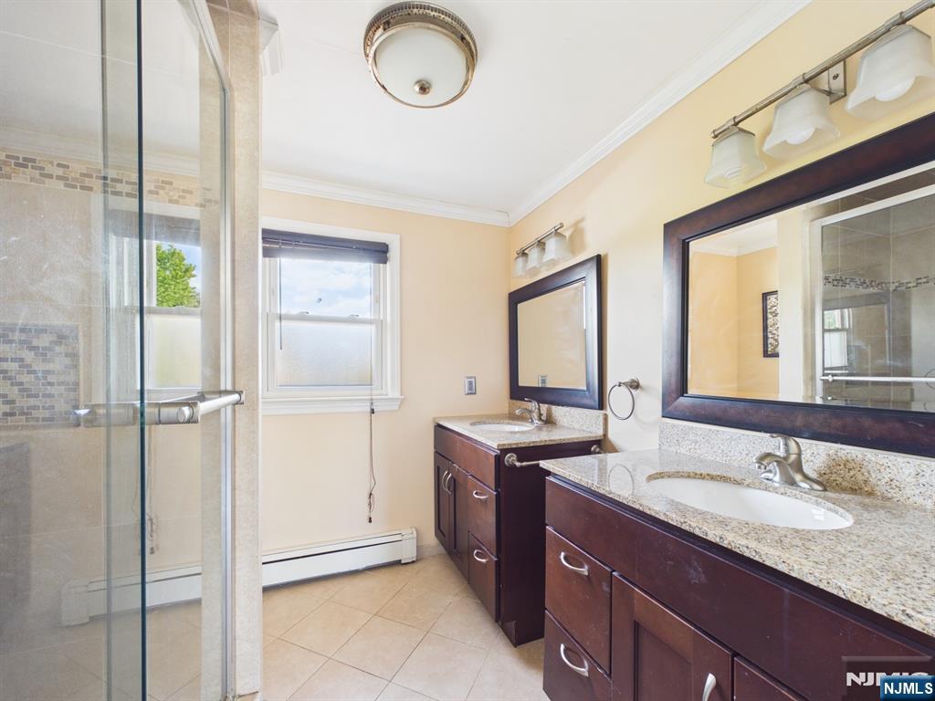 50 Hepburn Road Clifton, NJ 07012 - Photo 25 of 42 a bathroom with a granite countertop sink mirror and vanity
