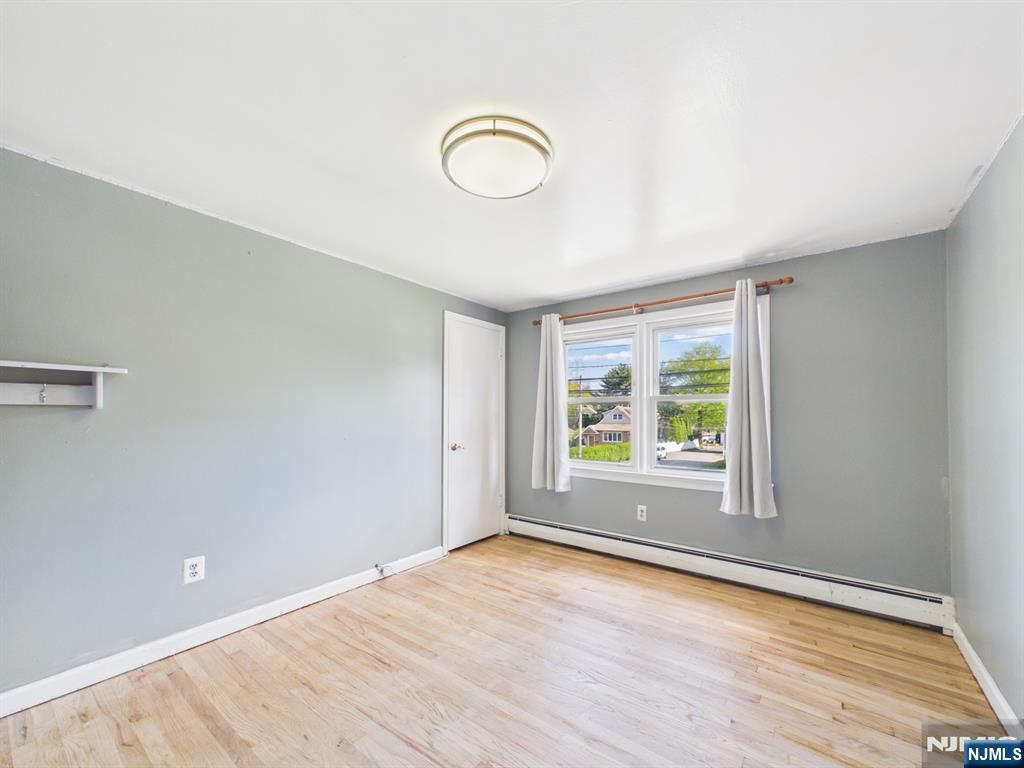 50 Hepburn Road Clifton, NJ 07012 - Photo 26 of 42 an empty room with wooden floor and windows