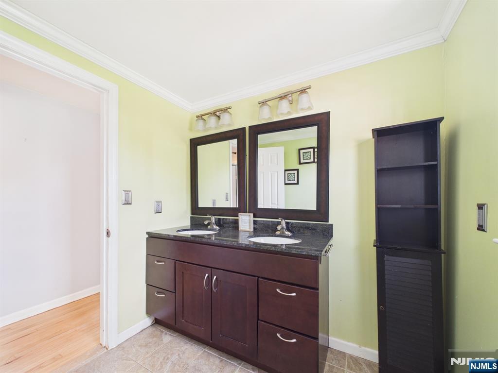50 Hepburn Road Clifton, NJ 07012 - Photo 27 of 42 a bathroom with a granite countertop sink and a mirror
