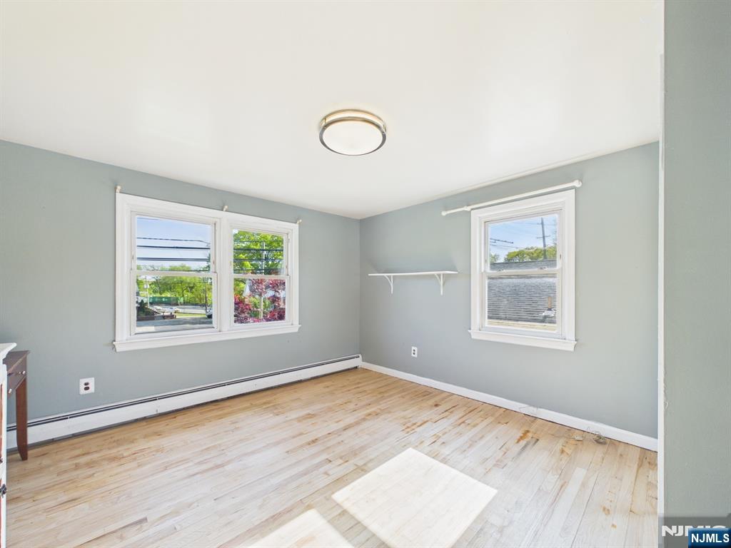 50 Hepburn Road Clifton, NJ 07012 - Photo 28 of 42 an empty room with wooden floor and windows