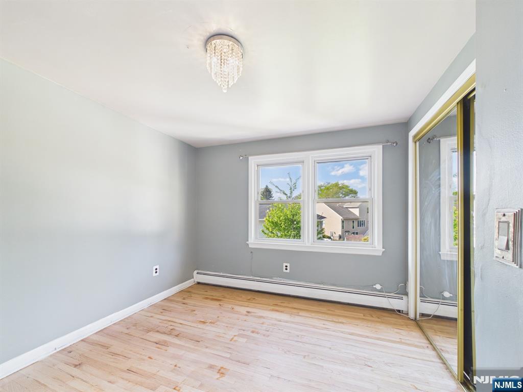 50 Hepburn Road Clifton, NJ 07012 - Photo 29 of 42 wooden floor in an empty room with a window