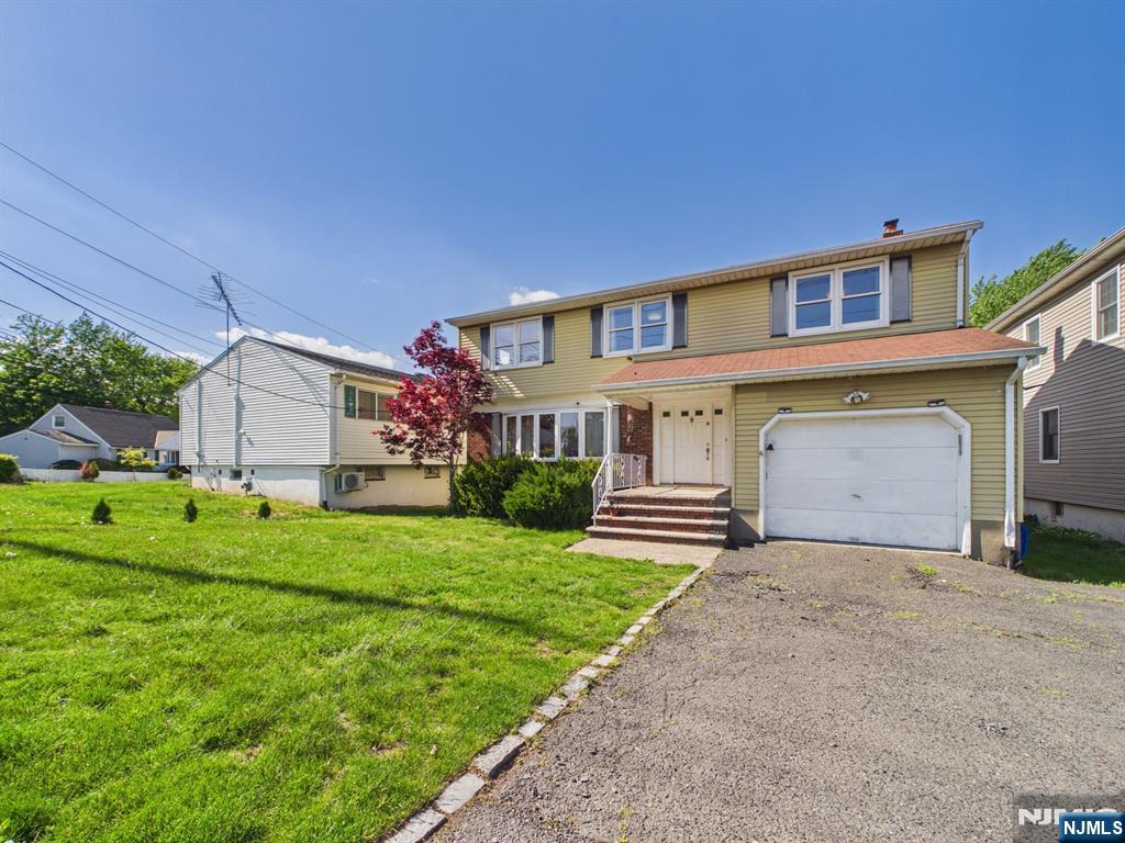 50 Hepburn Road Clifton, NJ 07012 - Photo 40 of 42 a front view of a house with a yard and garage