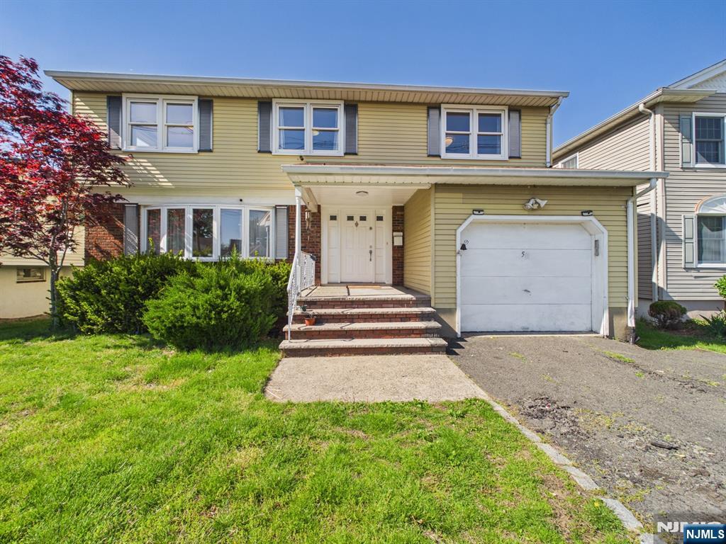 50 Hepburn Road Clifton, NJ 07012 - Photo 42 of 42 a front view of a house with a garden and trees