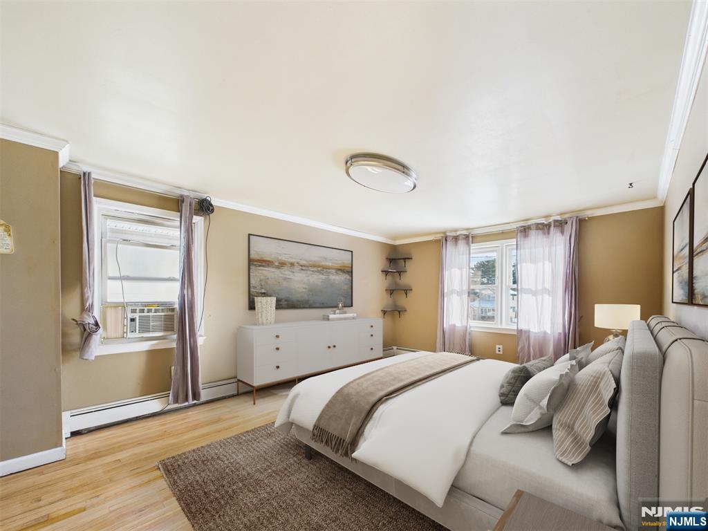 50 Hepburn Road Clifton, NJ 07012 - Photo 9 of 42 a bedroom with a large bed and wooden floor