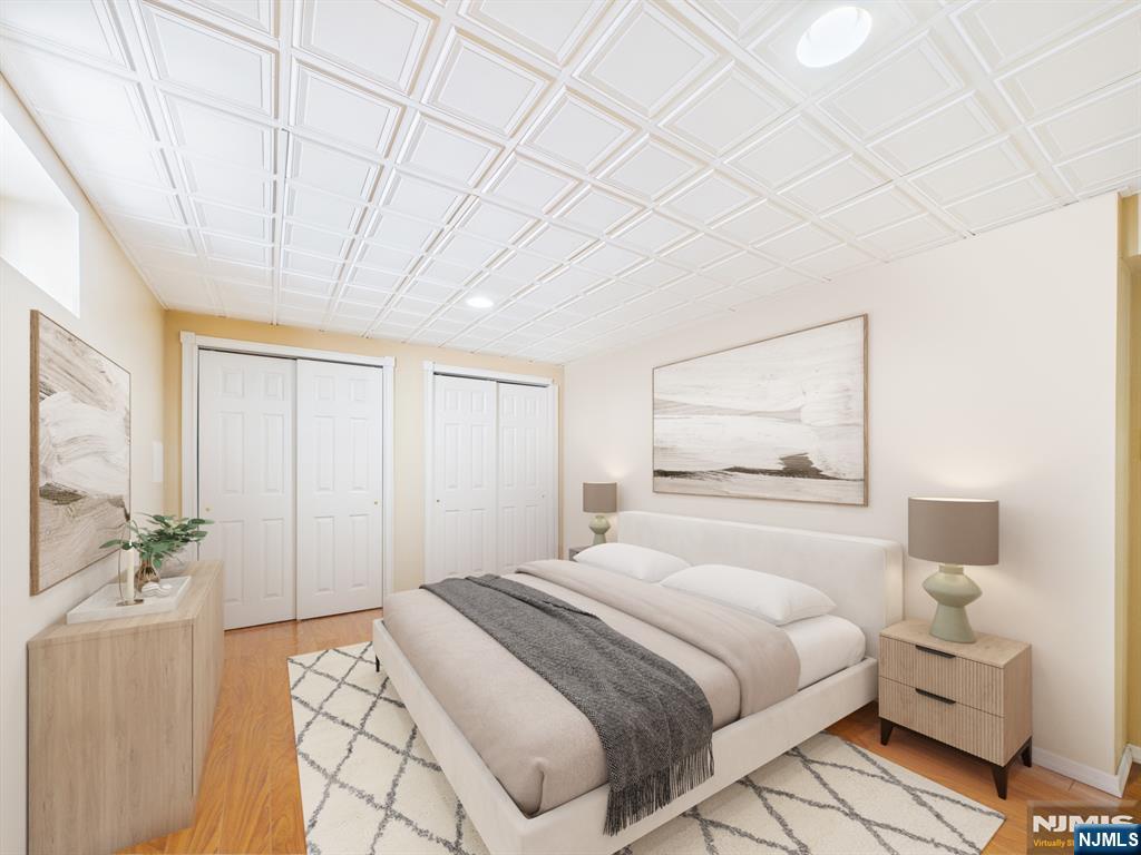 50 Hepburn Road Clifton, NJ 07012 - Photo 10 of 42 a bedroom with a bed and a painting on the wall