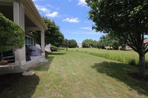 109 Ranier Lane Georgetown, TX 78633 - Photo 18 of 18 An inviting covered patio opens to an expansive lawn, perfect for outdoor leisure.