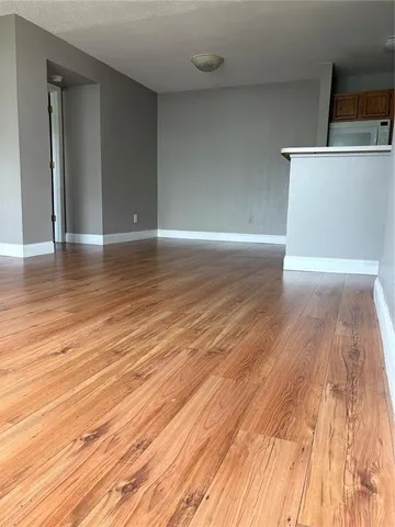 a view of a room with wooden floor