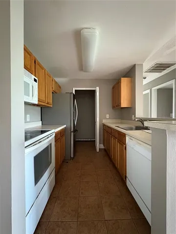 a kitchen with stainless steel appliances a stove sink and cabinets