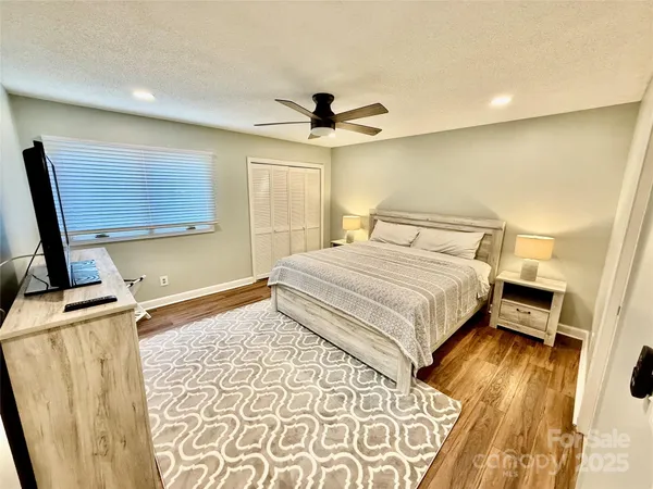 a bedroom with a bed and wooden floor