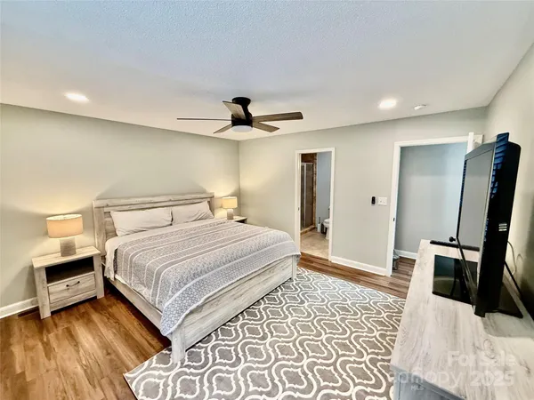 a bedroom with a bed and a mirror