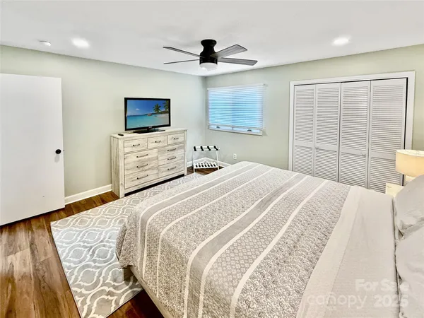 a bedroom with a bed and a tv