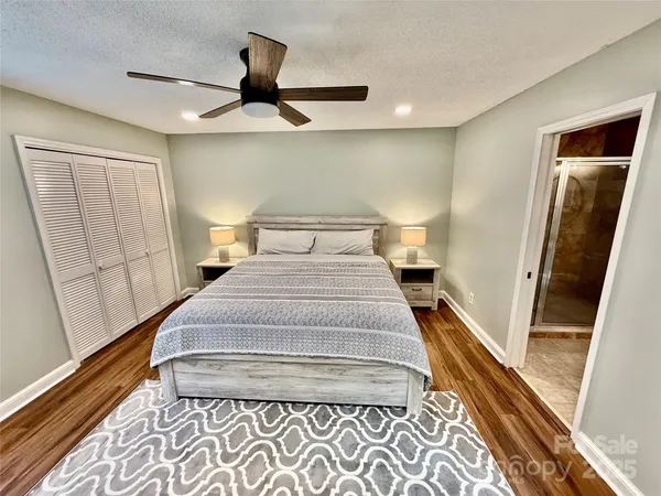 a bedroom with a bed and a large mirror