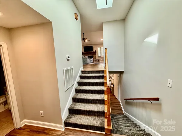 a view of entryway with wooden floor and stairs