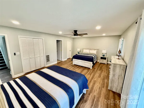 a bedroom with a bed and a mirror