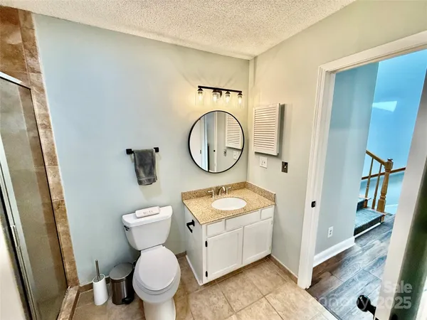 a white toilet sitting next to a bathroom sink