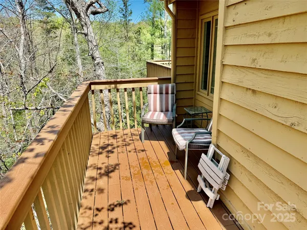 a view of balcony with wooden floor and outdoor seating