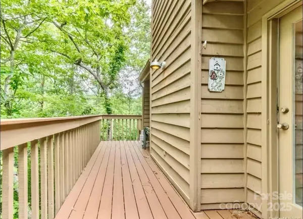 a view of a balcony with wooden floor and fence