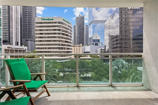 a view of a chair and table in the balcony