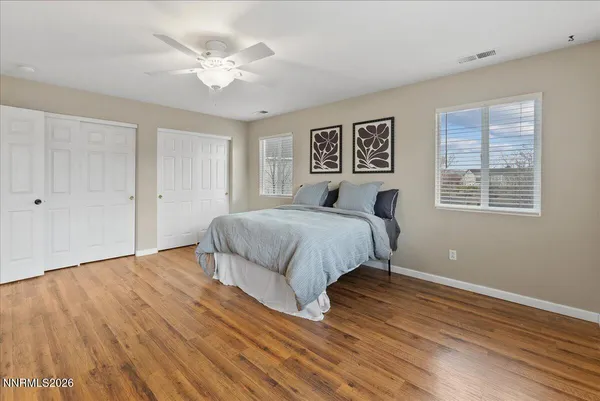 a bedroom with a bed and a ceiling fan