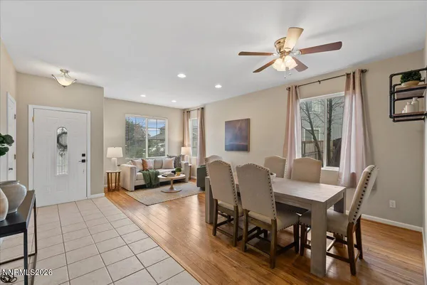 a view of a a dining room with furniture window and wooden floor