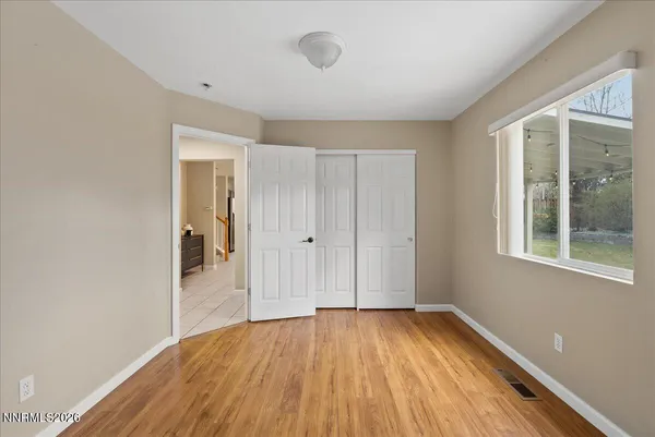 a view of a room with wooden floor and windows