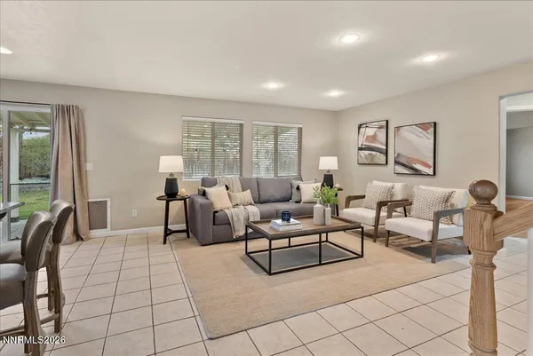 a living room with furniture and large windows