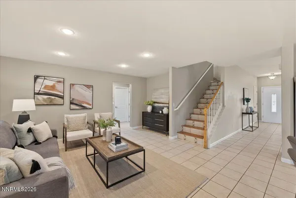 a living room with furniture and stairs